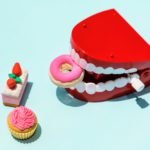 False teeth with donuts and cakes