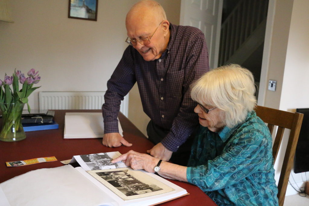 Enid and Barry Reeves look back through a photo album